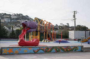 Purple dragon playground sculpture with red tongue slide